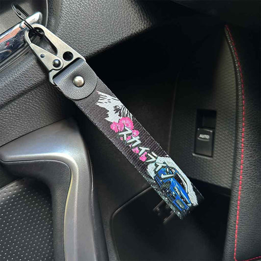 A Nisan Skyline keychain with 'Skyline' in Japanese characters hung in a GTR34