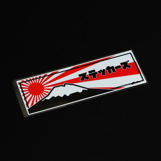 A Fuji Mountain slap sticker flat laid on a black background
