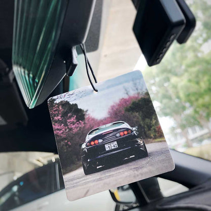 An air freshener with a pattern of the back of a Supra hung on car's rearview mirror