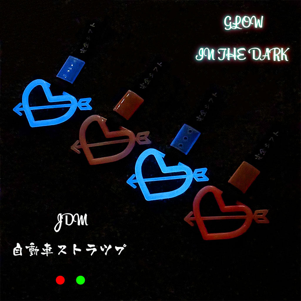 Glow-in-the-dark tsurikawas flat laid on the concrete ground and showing blue and red