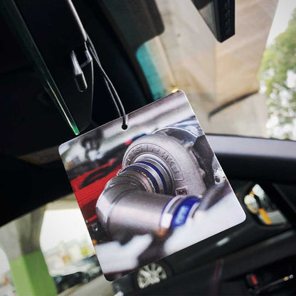 An air freshener with the pattern of a big turbo hung on a car's rearview mirror