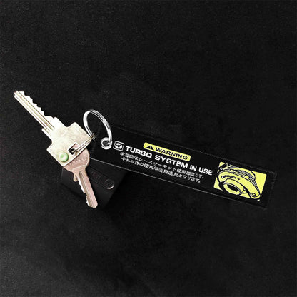 A jet tag with yellow image of a turbo and white characters holding two keys on a black background