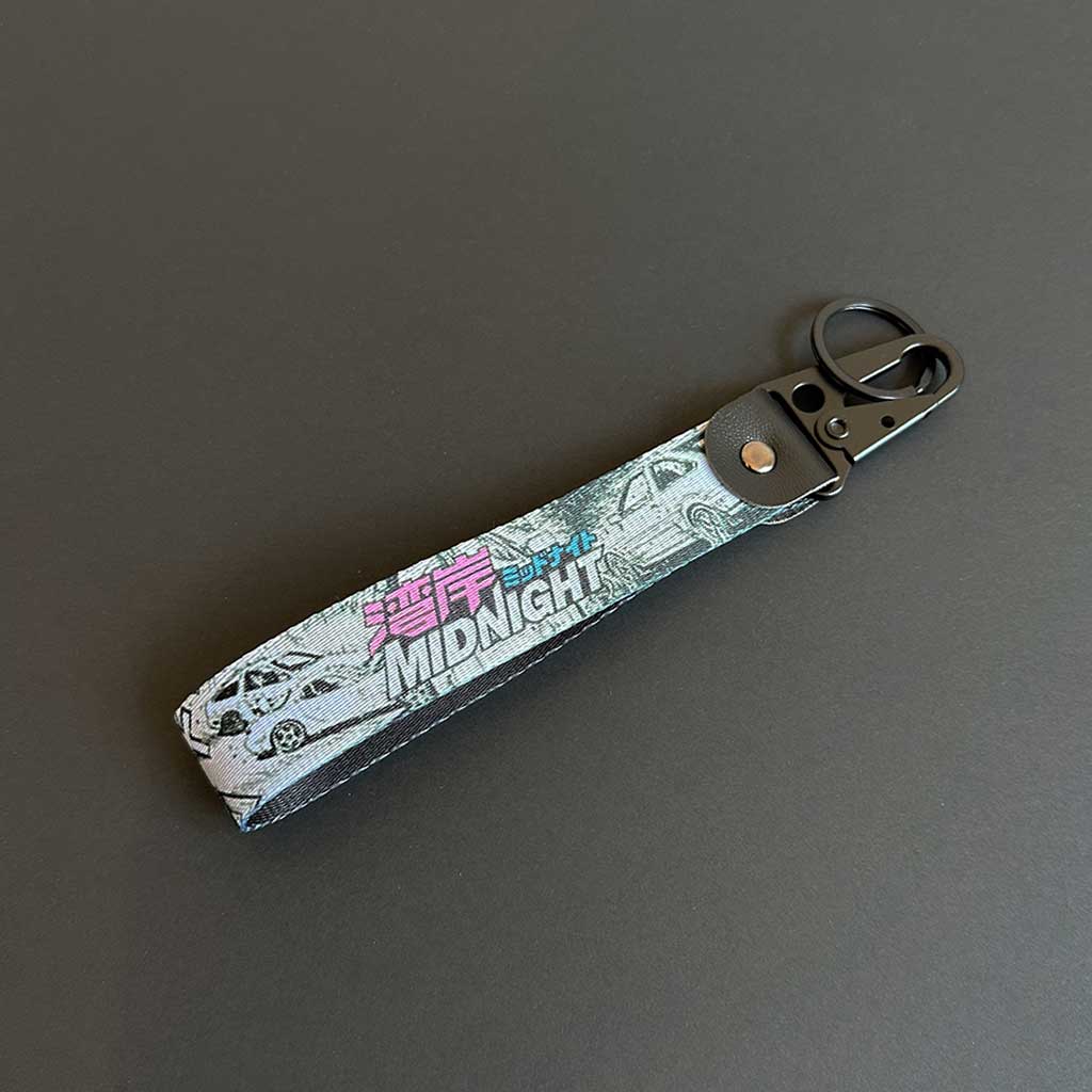 A Wangan expressway-themed lanyard flat laid on a black background